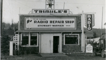 Black and white photo of Trimble Radio Repair Shop with a large transmitter tower on it, 1930s