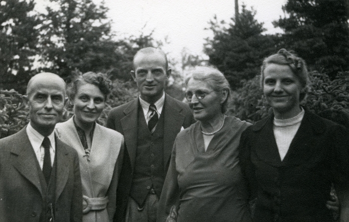 black and white photo of five siblings standing next to each other outside. Each is wearing nice clothing and it's focused on their upper bodies. ca. 1929.