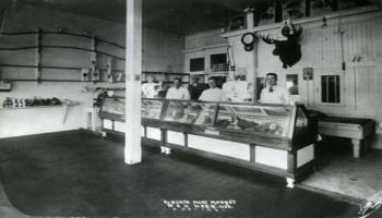 Black and white photo of inside the Alberta Meat Market in 1931.
