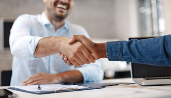 Two people shaking hands for a deal