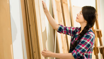 Photo of woman putting up plywood boards