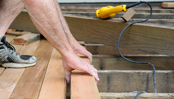 hands building a deck